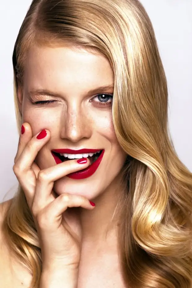 studio portrait of beautiful smiling woman with bright make-up