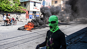 Мужчина в маске на одной из улиц столицы Гаити